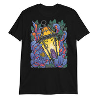 A black t-shirt with Chrysanthemum petals in blues and reds wrapped around an antique lantern lit by a candle. Dark green leaves behind the flower petals.