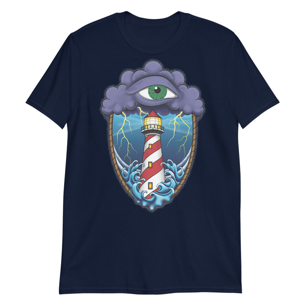 A navy blue t-shirt with an old school eye of the storm tattoo design of large dark purple storm clouds at the top of the design with a green eye in the middle of the clouds.  Below the clouds is an oval shape with brown rope. Inside the rope are stormy seas and a lighthouse with lightning striking in the background.  At the bottom of the design, some of the waves are spilling out of the rope barrier. The sky and seas are hues of blue; the lighthouse is white and red striped like a barber pole.