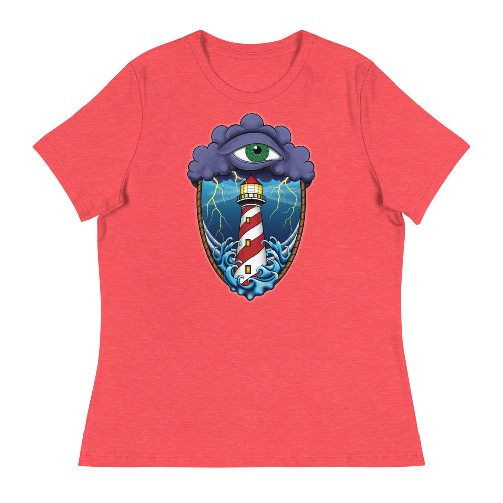 A medium red t-shirt with an old school eye of the storm tattoo design of large dark purple storm clouds at the top of the design with a green eye in the middle of the clouds.  Below the clouds is an oval shape with brown rope. Inside the rope are stormy seas and lightning striking at a lighthouse that is white and red striped like a barber pole.