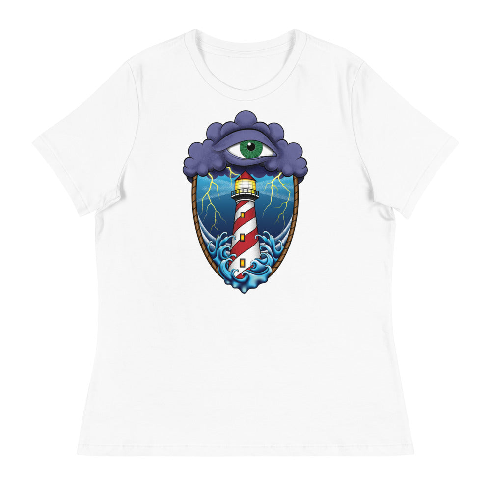 A white t-shirt with an old school eye of the storm tattoo design of large dark purple storm clouds at the top of the design with a green eye in the middle of the clouds.  Below the clouds is an oval shape with brown rope. Inside the rope are stormy seas and lightning striking at a lighthouse that is white and red striped like a barber pole.