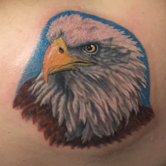 Realistic color eagles head tattoo.