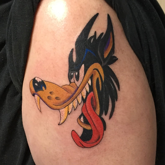 Tattoo of a cartoon wolf head with tounge hanging out.