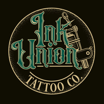 A black background with a gold circle containing fancy lettering in green and gold that says Ink Union and a gold tattoo machine peeking out from behind on the right side.  There is a dot work gradient inside the circle, and the words Tattoo Co. in gold are at the bottom of the design.