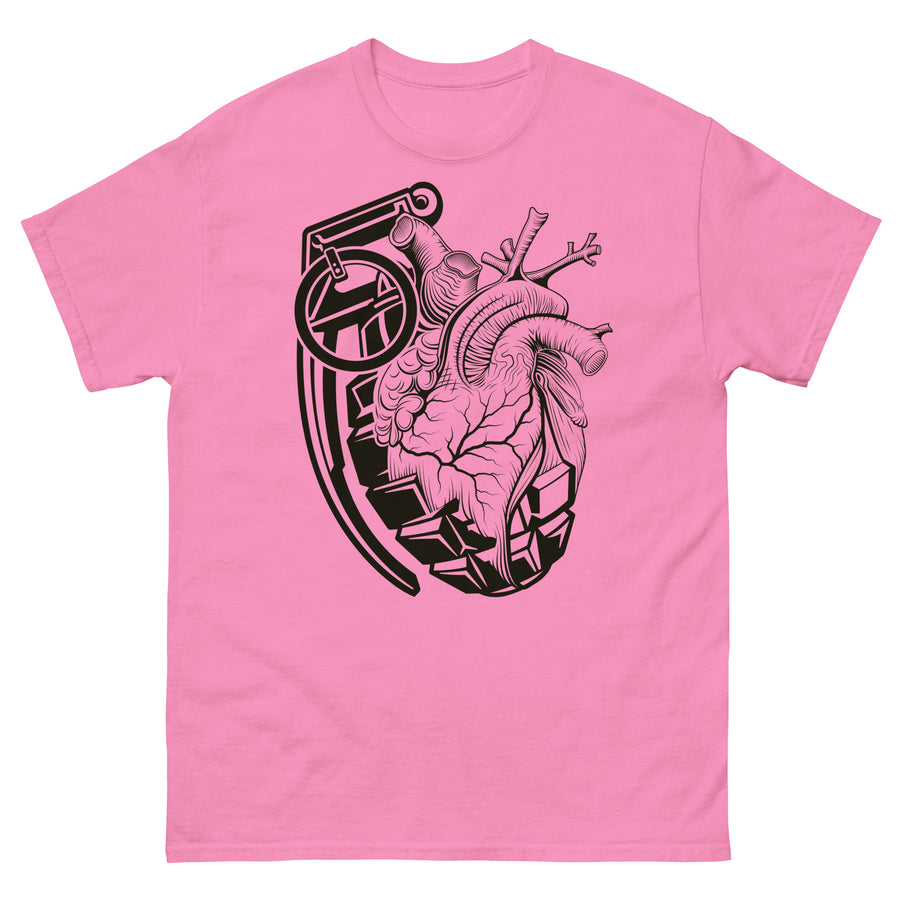 A pink t-shirt with a black grenade of sold color and line work morphing into an anatomical heart drawn using line work and hatching for shading at the top right of the image.