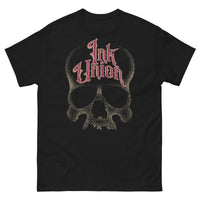 A black t-shirt adorned with a gold dot work human skull  and the words Ink Union in fancy gold and red lettering across the forehead of the skull.