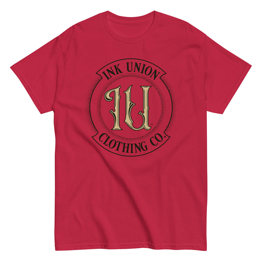 A cardinal red t-shirt with the Ink Union Clothing Co Badge logo in black and gold centered on the front of the shirt.