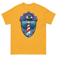 A golden yellow t-shirt with an old school eye of the storm tattoo design of large dark purple storm clouds at the top of the design with a green eye in the middle of the clouds.  Below the clouds is an oval shape with brown rope. Inside the rope are stormy seas and a lighthouse with lightning striking in the background.  At the bottom of the design, some of the waves are spilling out of the rope barrier. The sky and seas are hues of blue; the lighthouse is white and red striped like a barber pole.