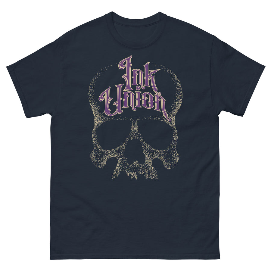 A navy blue t-shirt adorned with a gold dot work human skull  and the words Ink Union in fancy gold and purple lettering across the forehead of the skull.