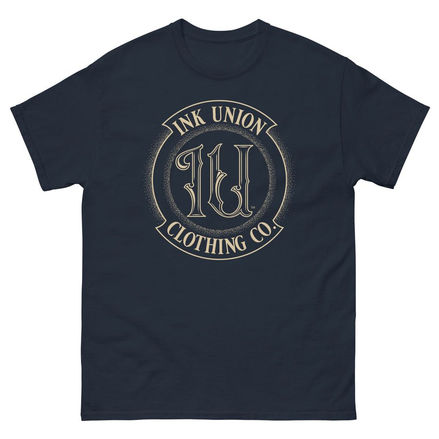 A navy blue t-shirt adorned with the Ink Union Clothing Co gold badge logo containing fancy lettering and dot work gradients.