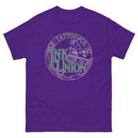 A purple t-shirt adorned with the Ink Union Tattoo Co. green and gold with a silver tattoo machine logo.