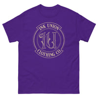 A purple t-shirt adorned with the Ink Union Clothing Co gold badge logo containing fancy lettering and dot work gradients.