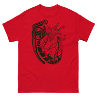 A red t-shirt with a black grenade of sold color and line work morphing into an anatomical heart drawn using line work and hatching for shading at the top right of the image.