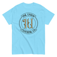 A sky blue t-shirt with the Ink Union Clothing Co Badge logo in black and gold centered on the front of the shirt.