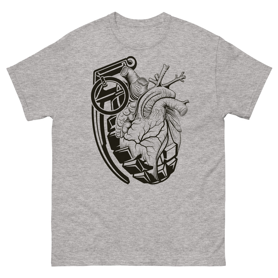 A medium grey t-shirt with a black grenade of sold color and line work morphing into an anatomical heart drawn using line work and hatching for shading at the top right of the image.