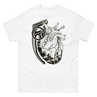 A white t-shirt with a black grenade of sold color and line work morphing into an anatomical heart drawn using line work and hatching for shading at the top right of the image.