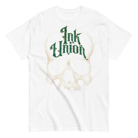 A white t-shirt adorned with a gold dot work human skull  and the words Ink Union in fancy gold and green lettering across the forehead of the skull.