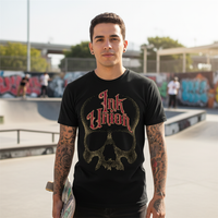 Red & Gold Dot Work Skull Tee — Tattooed Latino male model wearing black Ink Union Tattoo Co. red and gold dot work skull graphic tee at skate park holding skateboard with concrete ramps in background — alternative streetwear, tattoo artist t-shirt, unisex graphic tee, edgy cool fashion