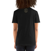 The back view of an attractive woman wearing a black t-shirt with a small gold Ink Union Badge Logo centered just under the neckline.
