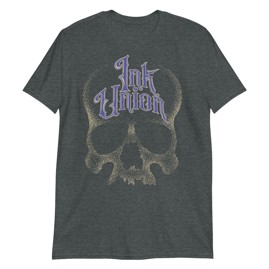 A dark grey t-shirt adorned with a gold dot work human skull  and the words Ink Union in fancy gold and blue lettering across the forehead of the skull.
