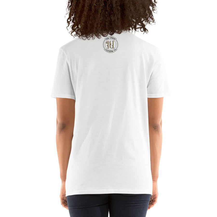 The rear view of an attractive woman wearing an Ink Union Clothing Co. white t-shirt featuring the Ink Union ring logo in black and gold.