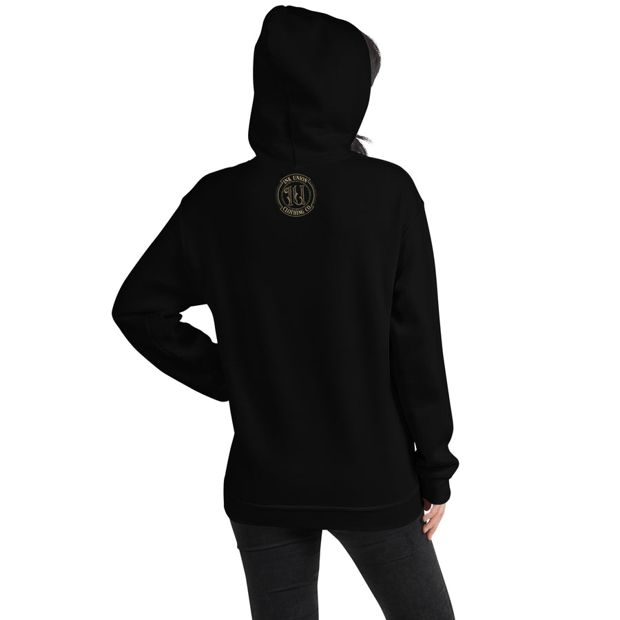 The back view of an attractive woman wearing a black hoodie with a small gold Ink Union Badge Logo centered just under the neckline.