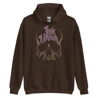 A dark brown hoodie adorned with a gold dot work human skull and the words Ink Union in fancy gold and purple lettering across the forehead of the skull.