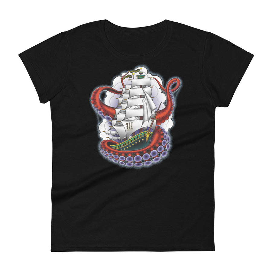 A black t-shirt with an old-school clipper ship tattoo design in green and brown with white sails surrounded by octopus tentacles in shades of red with purple tentacles. Behind the ship are purple-tinged clouds.