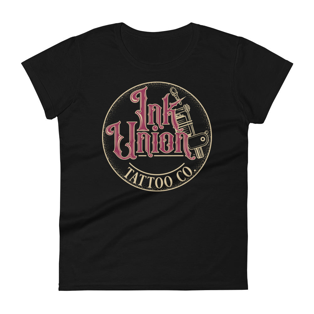 A black t-shirt with a gold circle containing fancy lettering in red and gold that says Ink Union and a gold tattoo machine peeking out from behind on the right side.  There is a dot work gradient inside the circle, and the words Tattoo Co. in gold are at the bottom of the design.