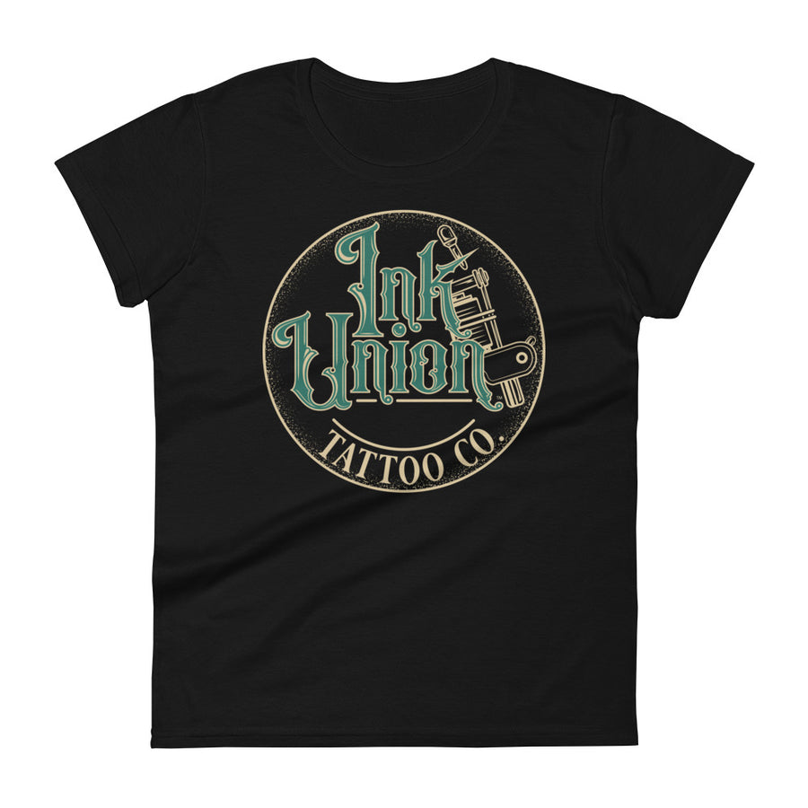 A black t-shirt with a gold circle containing fancy lettering in green and gold that says Ink Union and a gold tattoo machine peeking out from behind on the right side.  There is a dot work gradient inside the circle, and the words Tattoo Co. in gold are at the bottom of the design.