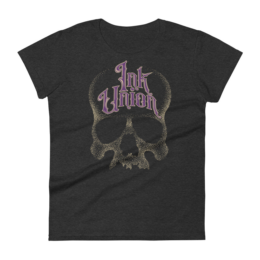 A dark grey t-shirt with a gold dot work human skull and the words Ink Union in fancy gold and purple lettering across the forehead of the skull.