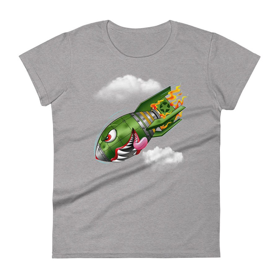 A light grey t-shirt with a military green neo-traditional bomb tattoo design. The bomb is falling with a look of determination in its eyes, an evil toothy grin, and its tongue hanging out of its mouth. Flames are coming from the back of the bomb, and some clouds are in the background.