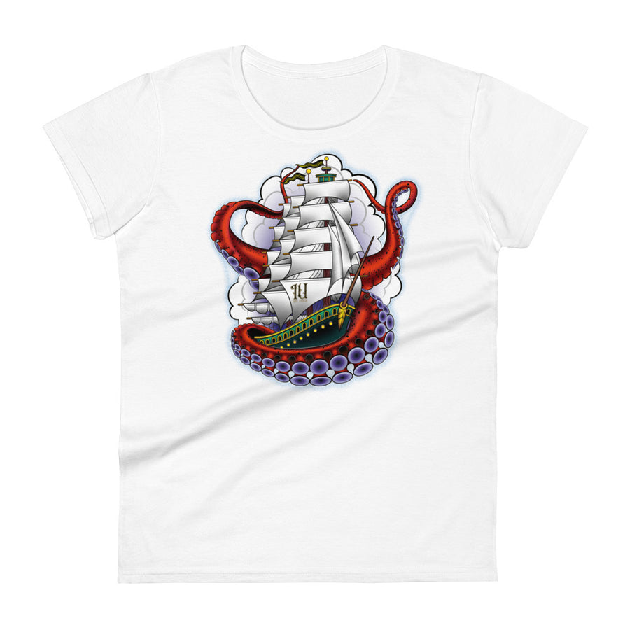 A white t-shirt with an old-school clipper ship tattoo design in green and brown with white sails surrounded by octopus tentacles in shades of red with purple tentacles. Behind the ship are purple-tinged clouds.