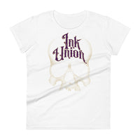 A white t-shirt adorned with a gold dot work human skull  and the words Ink Union in fancy gold and purple lettering across the forehead of the skull.