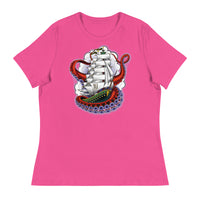A shocking pink t-shirt with an old-school clipper ship tattoo design in green and brown with white sails surrounded by octopus tentacles in shades of red with purple tentacles. Behind the ship are purple-tinged clouds.