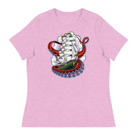 A lilac pink t-shirt with an old-school clipper ship tattoo design in green and brown with white sails surrounded by octopus tentacles in shades of red with purple tentacles. Behind the ship are purple-tinged clouds.