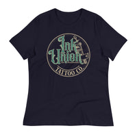 A navy blue t-shirt with a gold circle containing fancy lettering in green and gold that says Ink Union and a gold tattoo machine peeking out from behind on the right side.  There is a dot work gradient inside the circle, and the words Tattoo Co. in gold are at the bottom of the design.