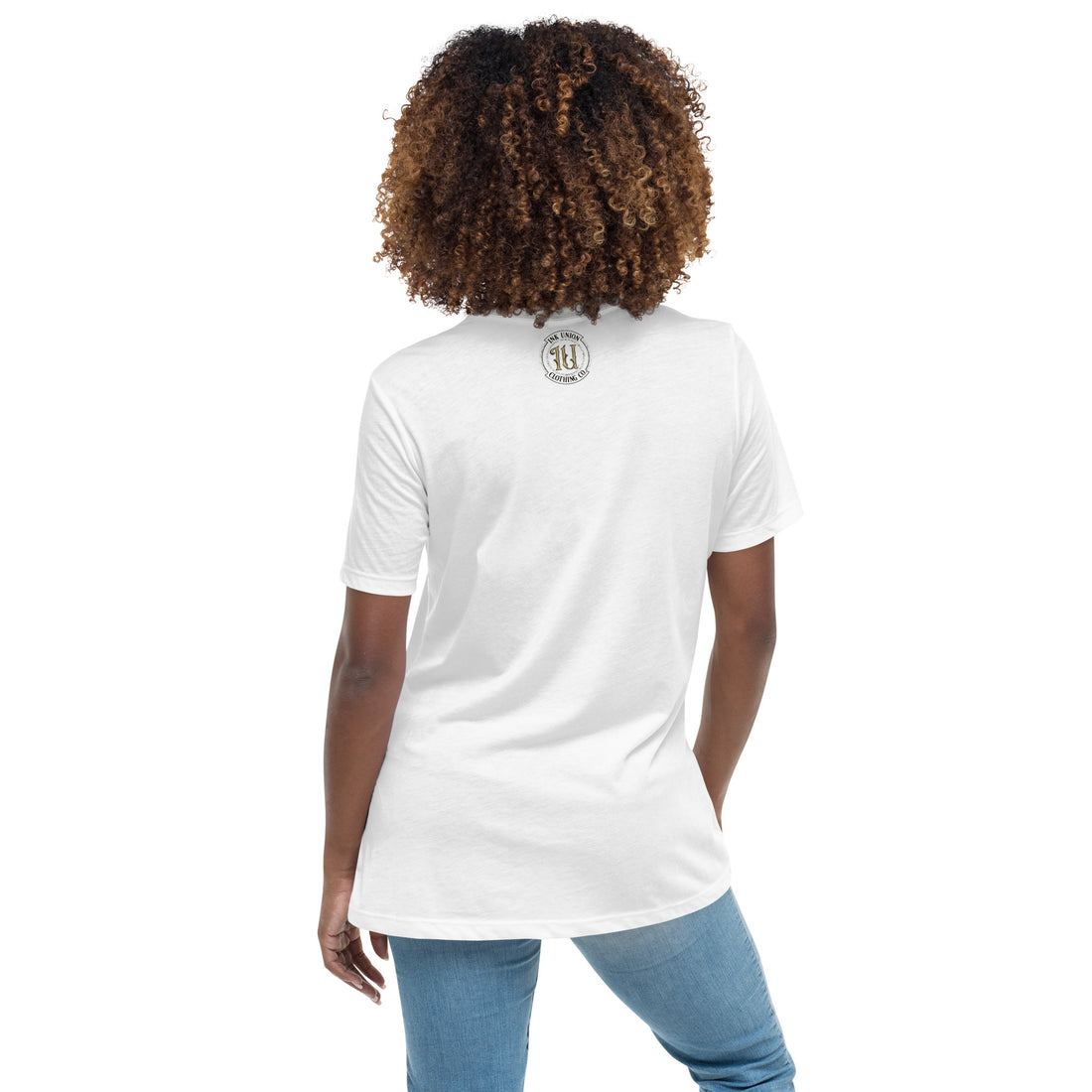 The back view of an attractive woman wearing a white t-shirt with a small gold and black Ink Union badge logo centered just under the neckline.
