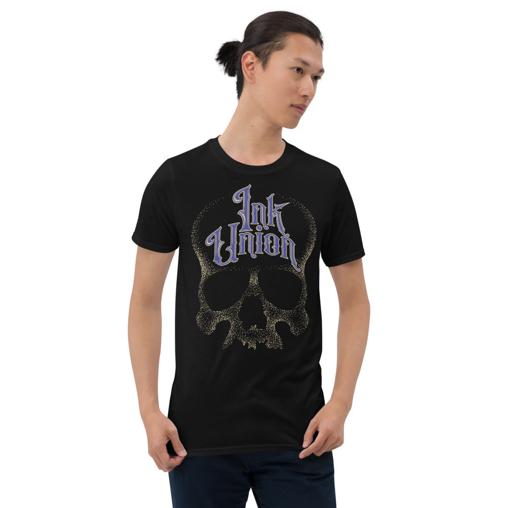 man wearing an Ink Union Clothing Co. unisex black t-shirt  featuring a large dot work gold skull centered on the shirt and Ink Union in large fancy gold and blue script across the forehead of the skull