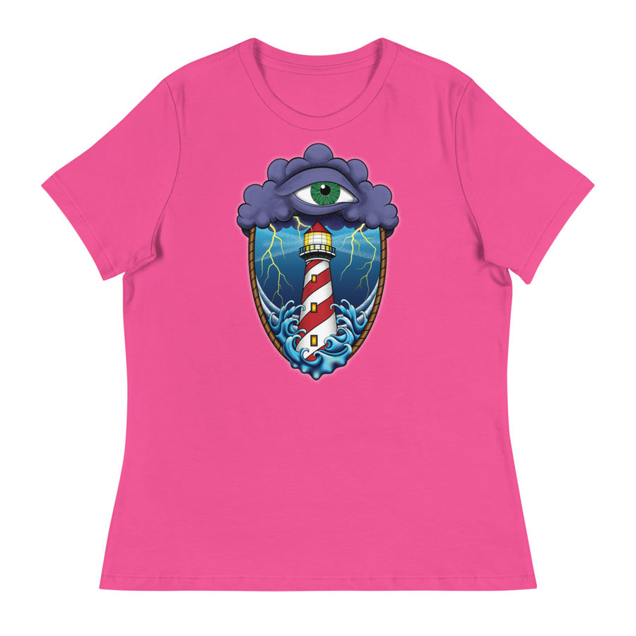 A pink t-shirt with an old school eye of the storm tattoo design of large dark purple storm clouds at the top of the design with a green eye in the middle of the clouds.  Below the clouds is an oval shape with brown rope. Inside the rope are stormy seas and lightning striking at a lighthouse that is white and red striped like a barber pole.