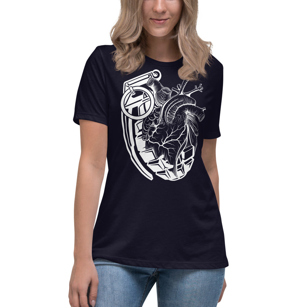 An attractive woman wearing a black t-shirt with a white grenade of sold color and line work morphing into an anatomical heart drawn using line work for shading at the top right of the image.